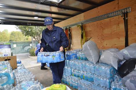 Petty Officer 1st Class James Prosser loads a trailer with water at Coast Guard Sector North Carolina in Wilmington, Oct. 16, 2016. Prosser organized donations from Coast Guardsmen and other Wilmington community members for residents of Lumberton, North Carolina, impacted by floodwaters after Hurricane Matthew. (U.S. Coast Guard photo by Petty Officer 2nd Class Nate Littlejohn/Released)