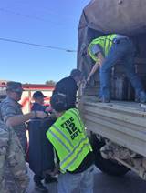 Local fire department rescue workers help flood survivors board a North Carolina Air National Guard 236th Brigade Engineer Battalion M35 2&frac12;-ton cargo truck in Lumberton, North Carolina, Oct. 10, 2016. The Lumber River flooded the city after Hurricane Matthew. (U.S. Coast Guard photo by Master Chief Petty Officer Louis Coleman/Released)
