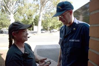 Coast Guard Petty Officer 1st Class James Prosser talks with a Lumberton, North Carolina, police offcer at the Chesnut St. United Methodist Church in Lumberton, North Carolina, Oct. 16, 2016. Prosser organized and helped deliver donations of food, water and other necessities for Lumberton residents impacted by floodwaters after Hurricane Matthew. (U.S. Coast Guard photo by Petty Officer 2nd Class Nate Littlejohn/Released)