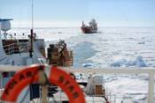 The crew of the motor vessel Ocean Giant lines up with the U.S. Coast Guard Cutter Polar Star as they prepare to be escorted to the National Science Foundation&rsquo;s McMurdo Station, Jan. 25, 2017.  The Polar Star&rsquo;s crew conducted a multi-hour escort, creating a safe and navigable path through the frozen Ross Sea to the station. U.S. Coast Guard photo by Chief Petty Officer David Mosley.