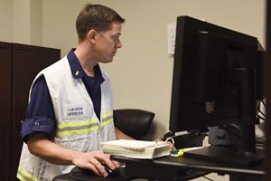 Coast Guard Ensign Eric Juback monitors his emails for information on Hurricane Irma at Air Station Miami, Sept. 8, 2017. An incident command post was established in preparation to Hurricane Irma that is expected to affect the majority of south Florida. U.S. Coast Guard photo by Petty Officer 1st Class Mark Barney. 