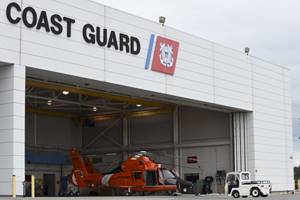 A Coast Guard MH-65 Dolphin is pushed into the hangar at Air Station Savannah, Ga., Sept. 9, 2017.