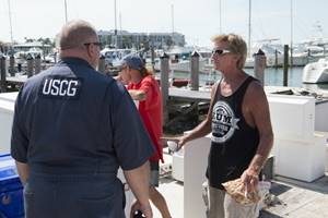 Chief Warrant Officer Todd Wardwell, incident management and environmental response at Coast Guard Sector Delaware Bay, Philadelphia, talks with a local mariner Sept. 15, 2017 in Key West, Florida.