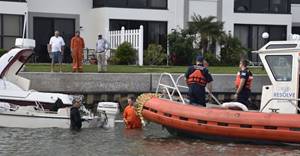 Coast Guard Petty Officer 2nd Class Mike Sullivan and Petty Officer 3rd Class Christopher Robel help offload lift supplies during a vessel removal operation, near Ward Island, Florida, in Pinellas County, October 7, 2017. The Coast Guard is overseeing the removal of vessels displaced by Hurricane Irma throughout Florida. U.S. Coast Guard photo by Petty Officer 1st Class Sara Romero.